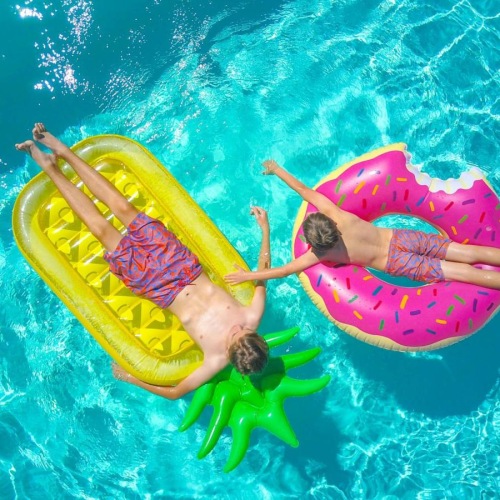 people on floaties in a pool