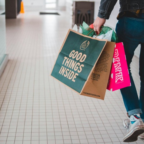 man with shopping bags and a camera