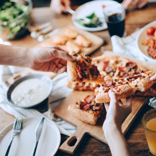 people eating pizza at a restaurant