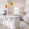 kitchen with large island and white cabinents