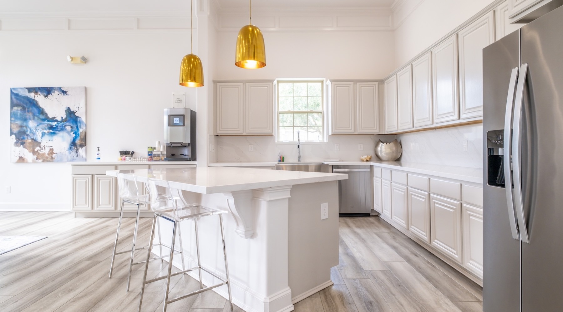 kitchen with large island and white cabinents