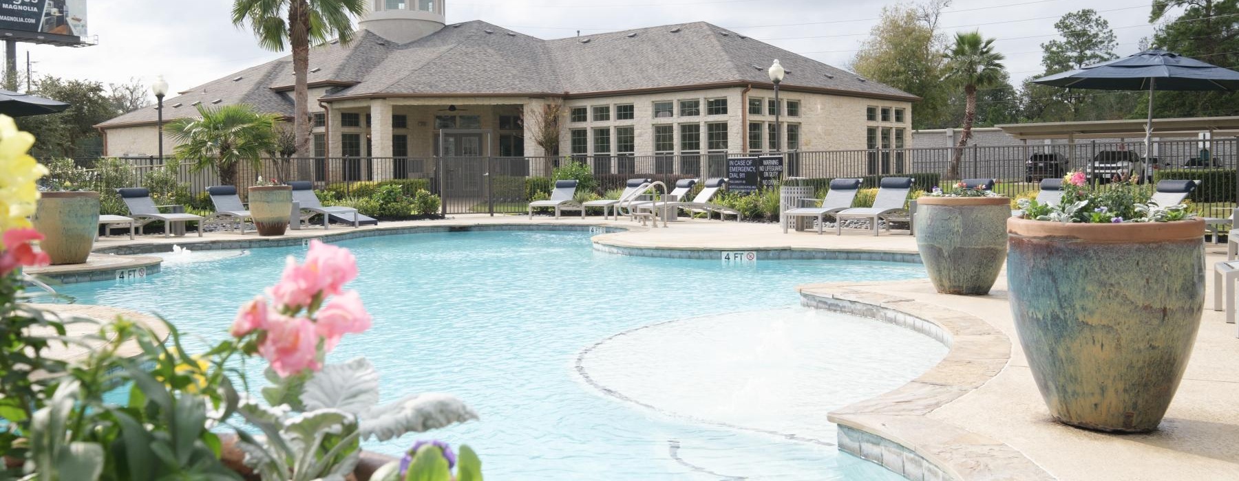 large potted plants around pool